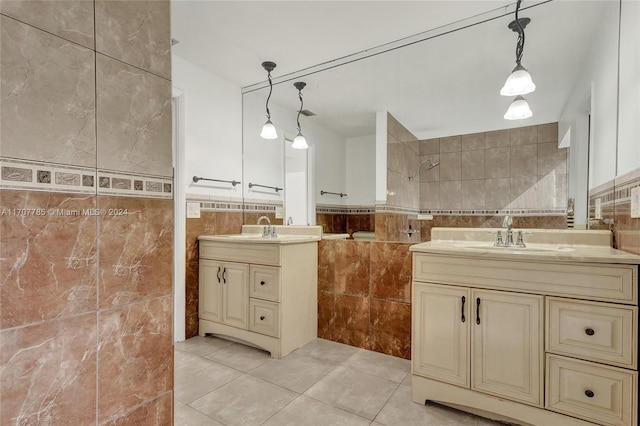 bathroom with tile patterned floors, vanity, and tile walls