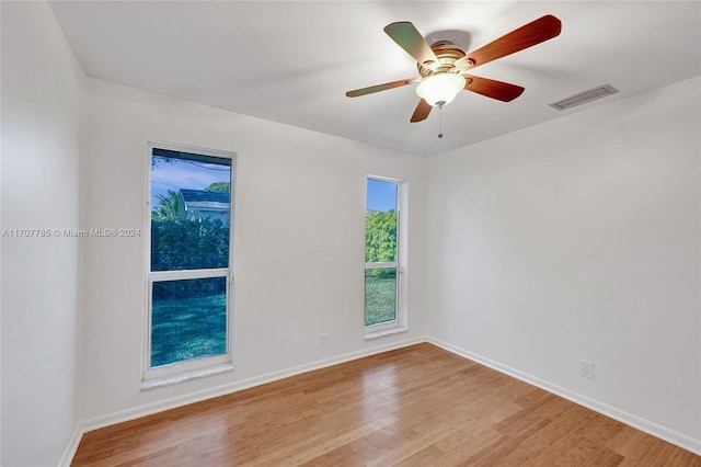 spare room with light hardwood / wood-style floors and ceiling fan