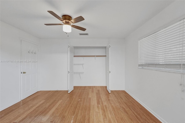 interior space featuring light wood-type flooring, a closet, and ceiling fan