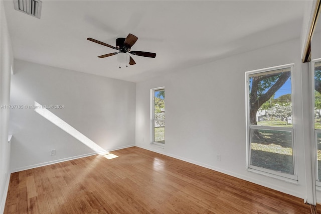 unfurnished room with ceiling fan and hardwood / wood-style flooring