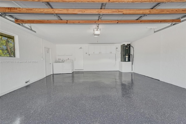 garage with washer and clothes dryer and a garage door opener