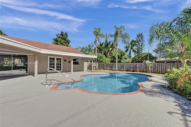 view of pool featuring a patio area and french doors