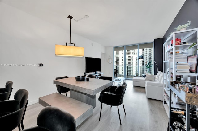 interior space featuring light hardwood / wood-style flooring, floor to ceiling windows, and lofted ceiling