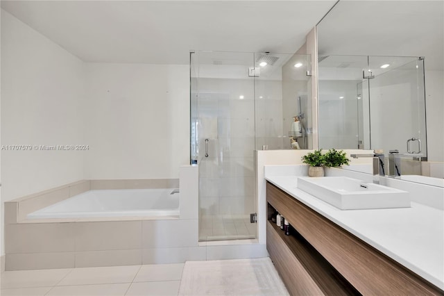 bathroom featuring tile patterned flooring, shower with separate bathtub, and vanity