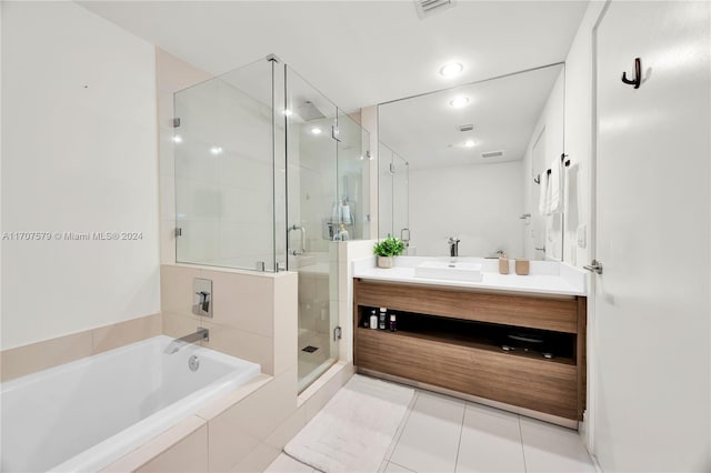 bathroom featuring tile patterned flooring, shower with separate bathtub, and vanity