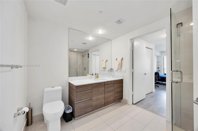 bathroom with hardwood / wood-style floors, vanity, toilet, and a shower with shower door