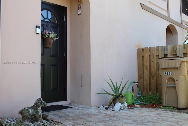 property entrance with stucco siding