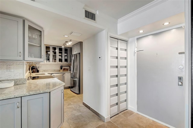 kitchen with gray cabinets and appliances with stainless steel finishes