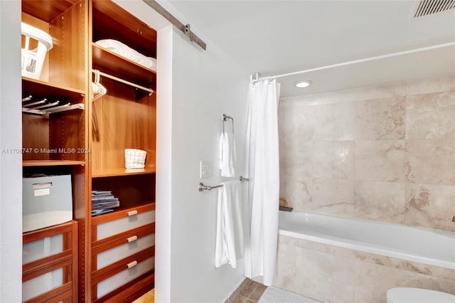 bathroom with tile patterned flooring and shower / bathtub combination with curtain