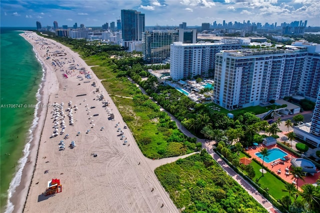 drone / aerial view featuring a view of the beach and a water view