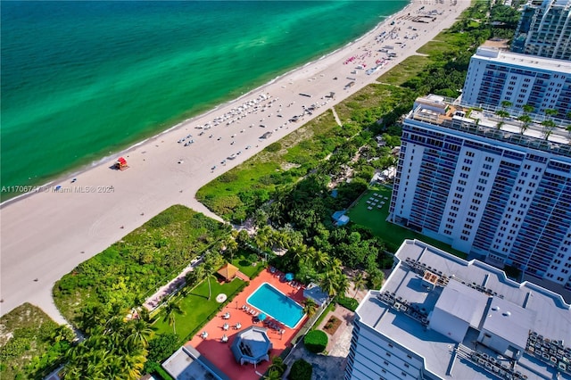 birds eye view of property with a water view and a view of the beach