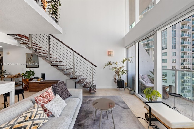 tiled living room featuring a healthy amount of sunlight and a high ceiling