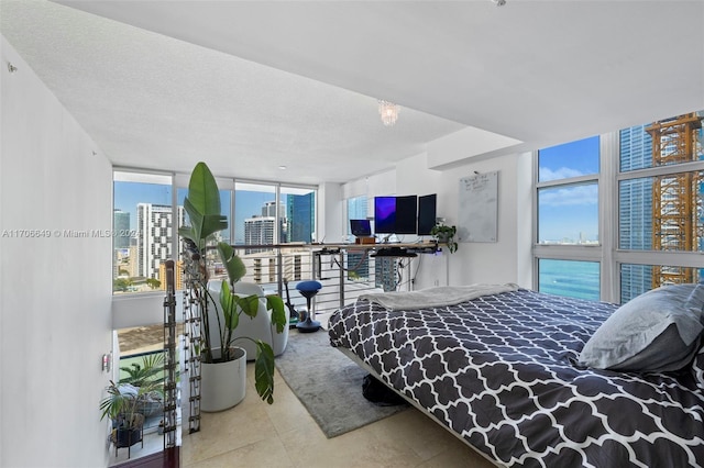 bedroom with expansive windows and a textured ceiling