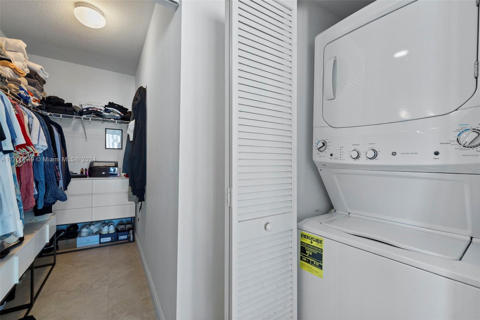 clothes washing area featuring a textured ceiling and stacked washer and dryer