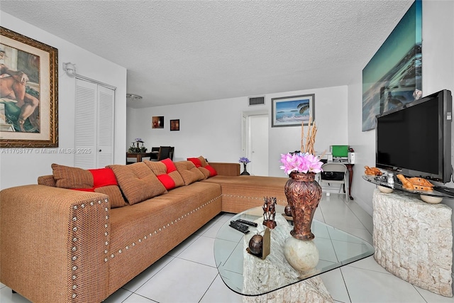 tiled living room with a textured ceiling