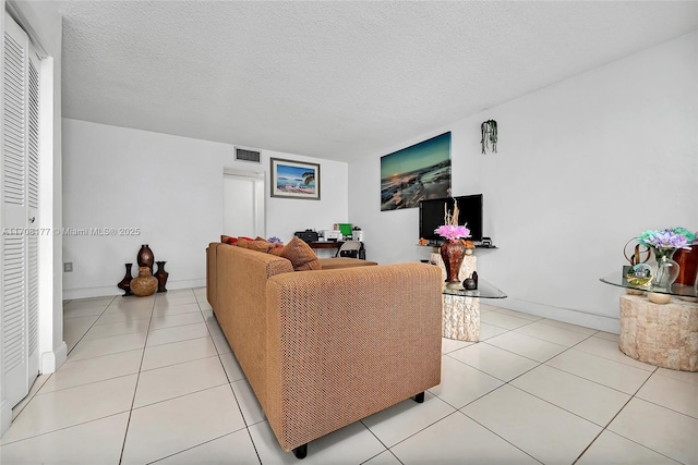 tiled living room with a textured ceiling