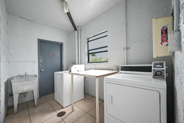 laundry area with light tile patterned floors and independent washer and dryer