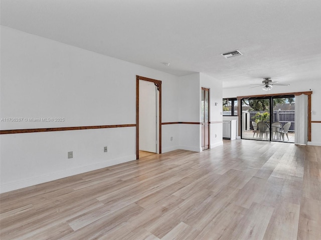 unfurnished room with ceiling fan, a textured ceiling, and light hardwood / wood-style floors