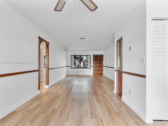 unfurnished living room with ceiling fan and light hardwood / wood-style flooring