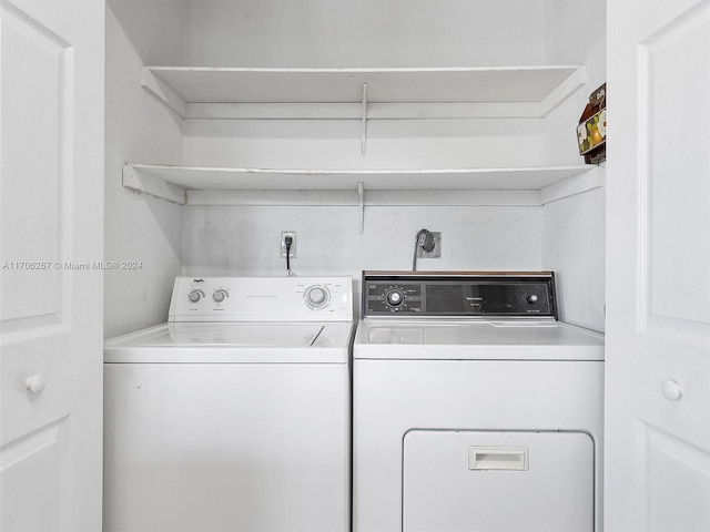 clothes washing area with washer and clothes dryer