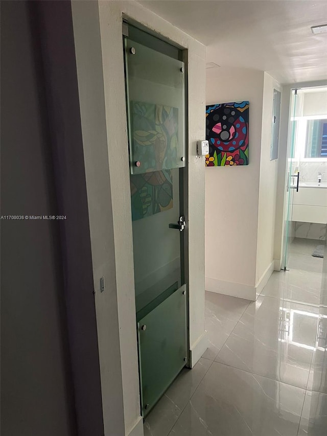 hallway featuring light tile patterned floors