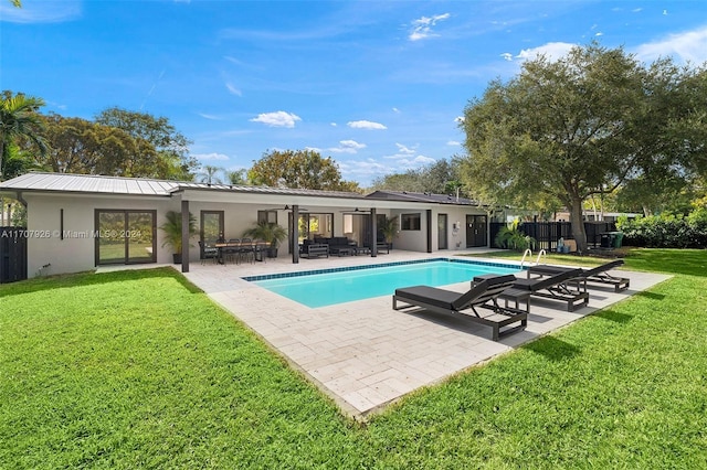 view of swimming pool featuring a patio area and a yard