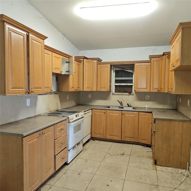 kitchen featuring light tile patterned floors, white appliances, and sink