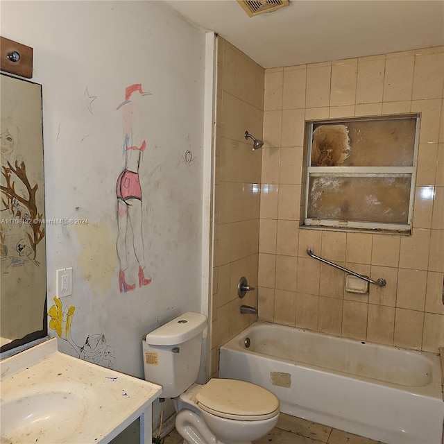 full bathroom with vanity, toilet, and tiled shower / bath combo