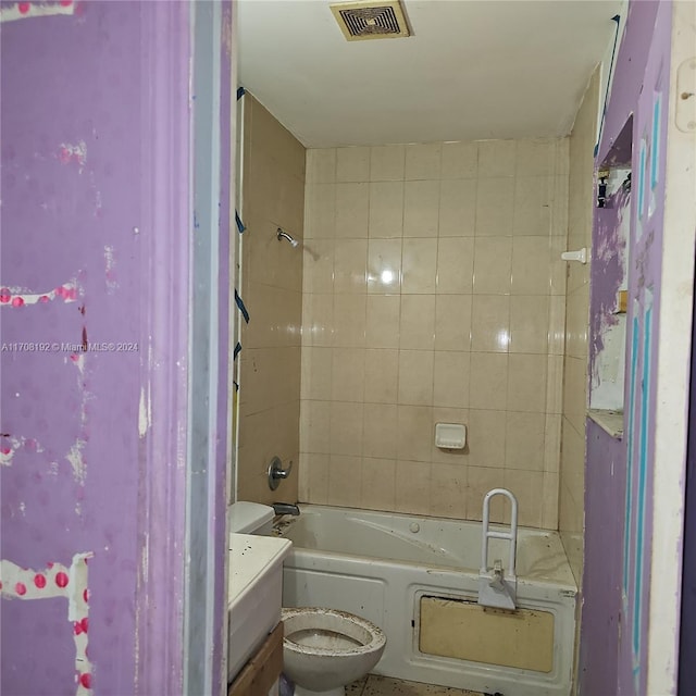 full bathroom with vanity, toilet, and tiled shower / bath combo