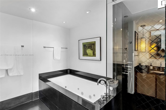 full bathroom with a whirlpool tub, tiled shower, and recessed lighting