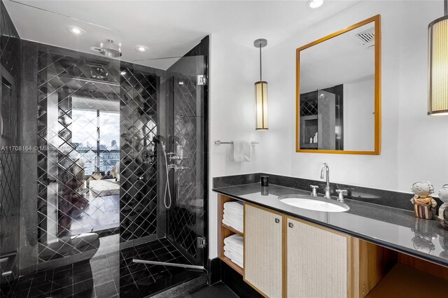 full bath with a stall shower, recessed lighting, and vanity