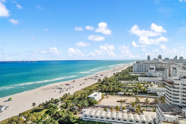 birds eye view of property featuring a water view, a view of the beach, and a city view