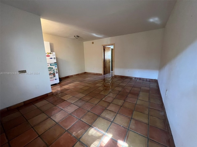 unfurnished room with dark tile patterned floors