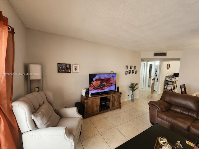 living room with light tile patterned floors and a textured ceiling