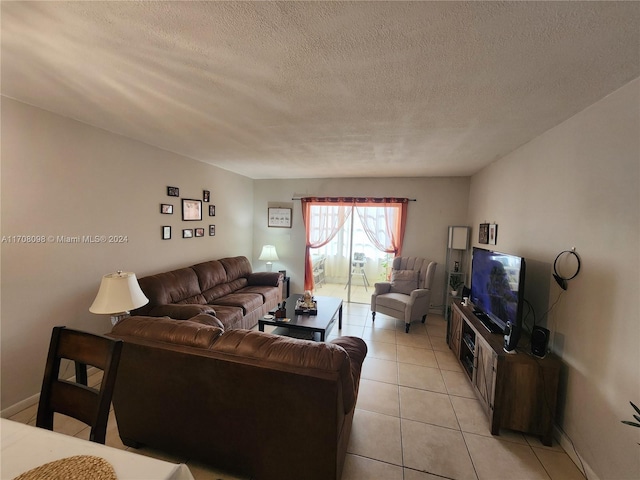 living room with light tile patterned flooring and a textured ceiling