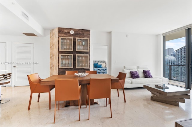 dining space featuring a wall of windows