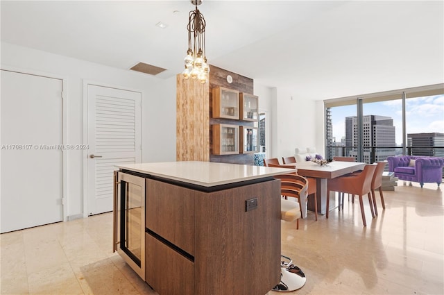 kitchen featuring wine cooler, a kitchen island, and pendant lighting