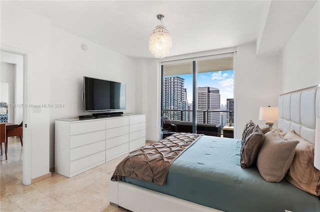 bedroom featuring access to outside and an inviting chandelier