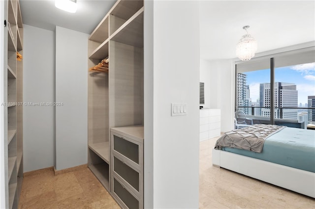 walk in closet featuring a chandelier