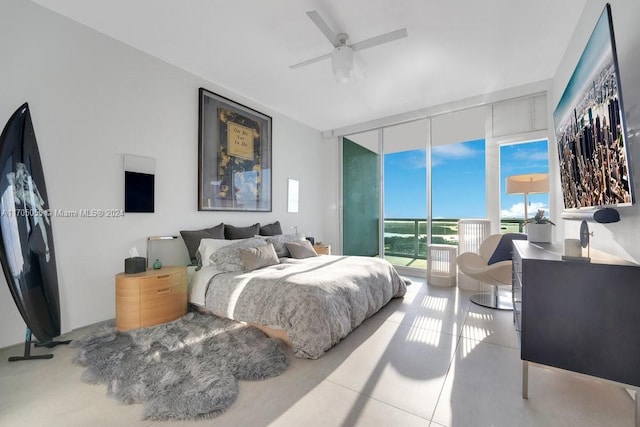 bedroom featuring access to outside, ceiling fan, and expansive windows