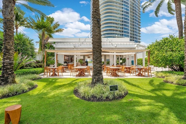 100 S Pointe Dr Unit 3601, Miami Beach, FL 33139 - rear view of house with a yard and a patio area