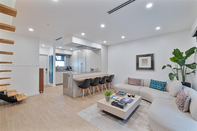 living room featuring light hardwood / wood-style floors and sink