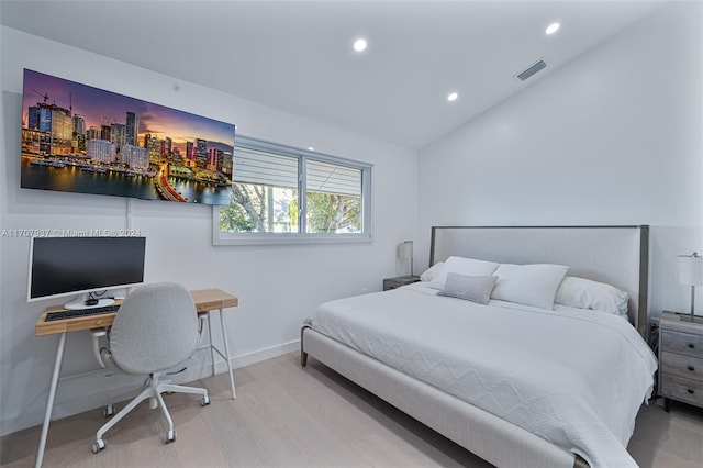 bedroom featuring light hardwood / wood-style floors and vaulted ceiling