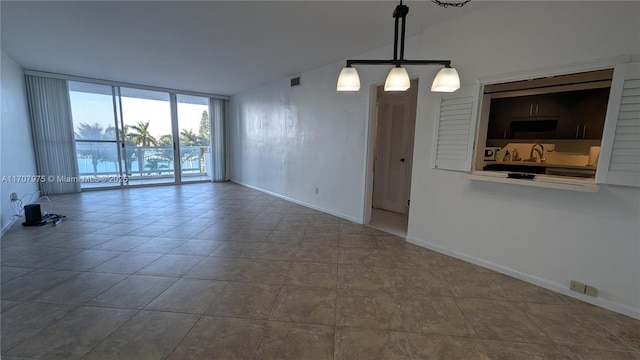 empty room featuring floor to ceiling windows and sink