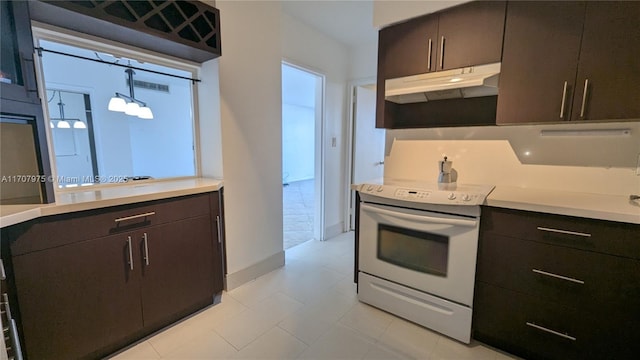 kitchen featuring decorative light fixtures, dark brown cabinetry, and white electric stove