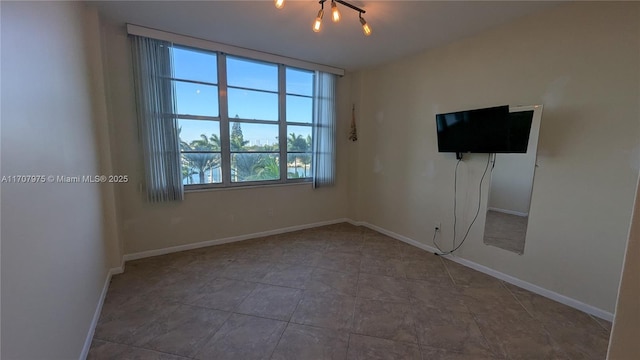 unfurnished room featuring a notable chandelier