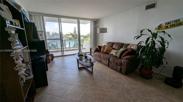 tiled living room with floor to ceiling windows