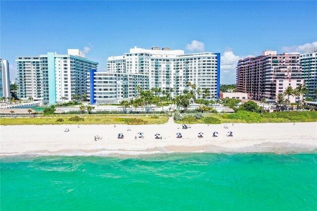 drone / aerial view with a water view and a beach view