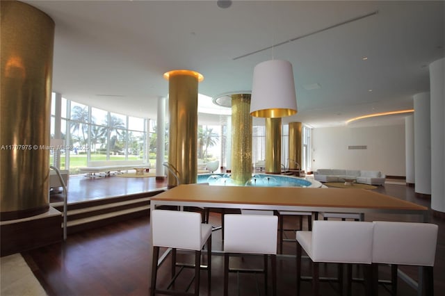 interior space featuring a kitchen bar and floor to ceiling windows