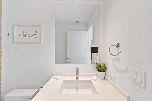 bathroom with vanity and toilet